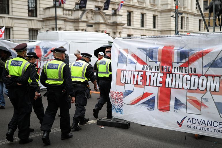 Police officers begin to move off after a march organised by Unite The Kingdom, in central London, on May 16, 2026 [AFP]