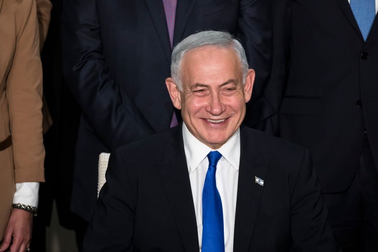 JERUSALEM, ISRAEL - DECEMBER 29: Israeli Prime Minister Benjamin Netanyahu smiles during a traditional government group photo at the President's house on December 29, 2022 in Jerusalem, Israel. Conservative Benjamin Netanyahu and a bloc of nationalist and religious parties won a clear election victory last month and will be sworn in as government to the Knesset today. This completes Netenyahu's political comeback with a record sixth term in office. (Photo by Amir Levy/Getty Images)