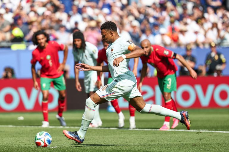 Kylian Mbappe takes a penalty.