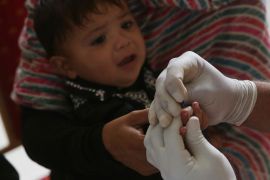 In this May 16, 2019 photo, A Pakistani doctor takes blood sample of a child during a screening camp in Ratodero, in southern province of Sindh in Pakistan. The worst HIV outbreak among children, many of them under 5 years old, occurred in Pakistan and a study released on Thursday, Dec. 19, blamed dirty needles and tainted blood but it also said the Pakistan government has to do more to understand how the virus went from high-risk groups like drug users and sex workers to the general population. (AP Photo/Fareed Khan)