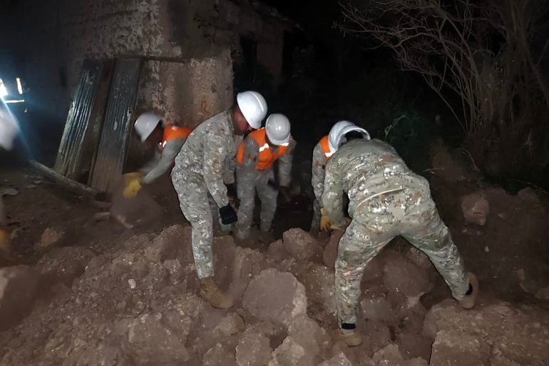 This handout picture released by Peru's Defence Ministry shows first responders searching through collapsed houses on the outskirts of Huancayo, about 300 km east of Lima in Junin Department, on July 19, 2026, following a 5.1 magnitude quake.