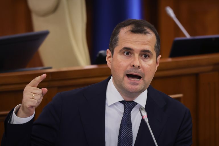 Prime Minister designate Vasile Tofan speaks before the parliament's confidence vote for the new government team in Chisinau, Moldova, Tuesday, July 21, 2026. (AP Photo/Aurel Obreja)