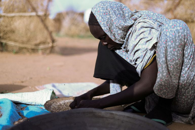 Displaced Sudanese mother of five Hanan Adam Hassan prepares food at a camp shelter in Tawila, North Darfur.[File: Reuters]